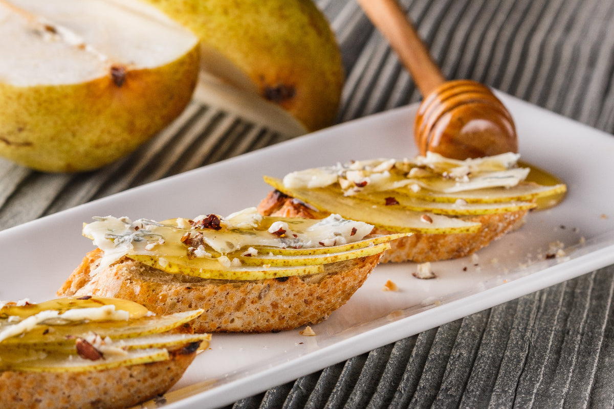 Pear and blue cheese bruschetta with honey, walnuts, and fresh pear slices.