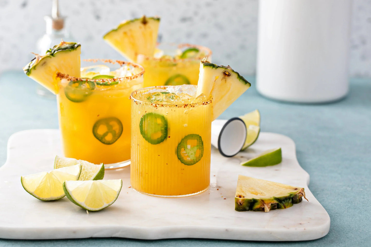Tropical pineapple jalapeño cocktails with lime wedges, perfect for flavor-forward drinks