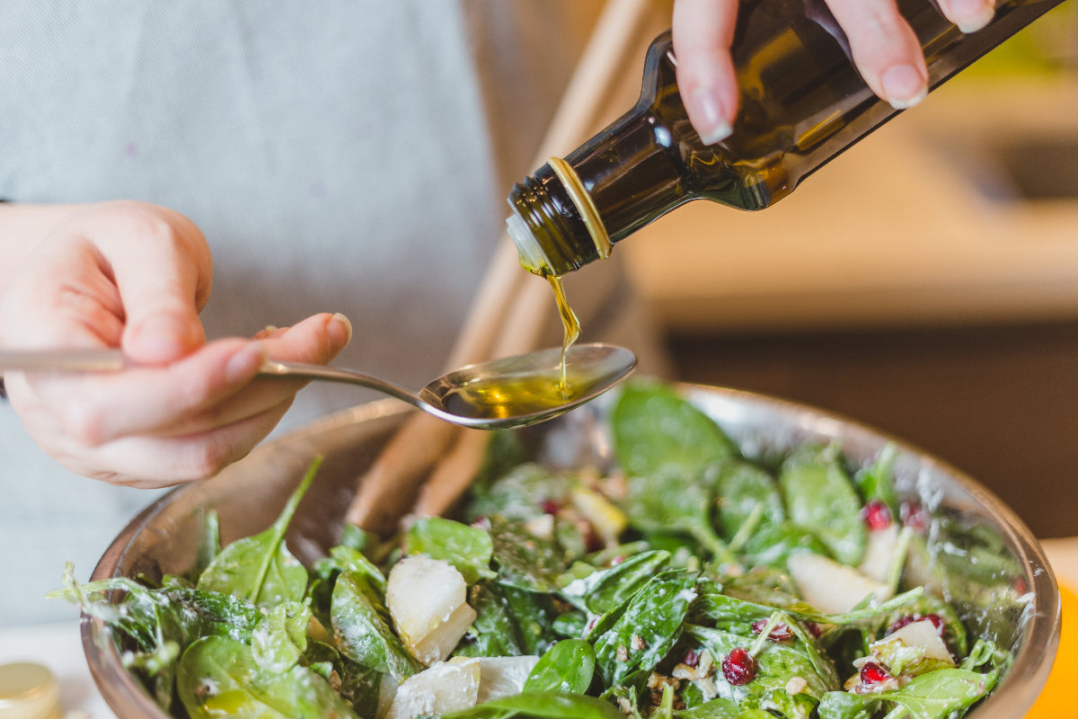 Preparing a fresh salad with finishing ingredients before serving