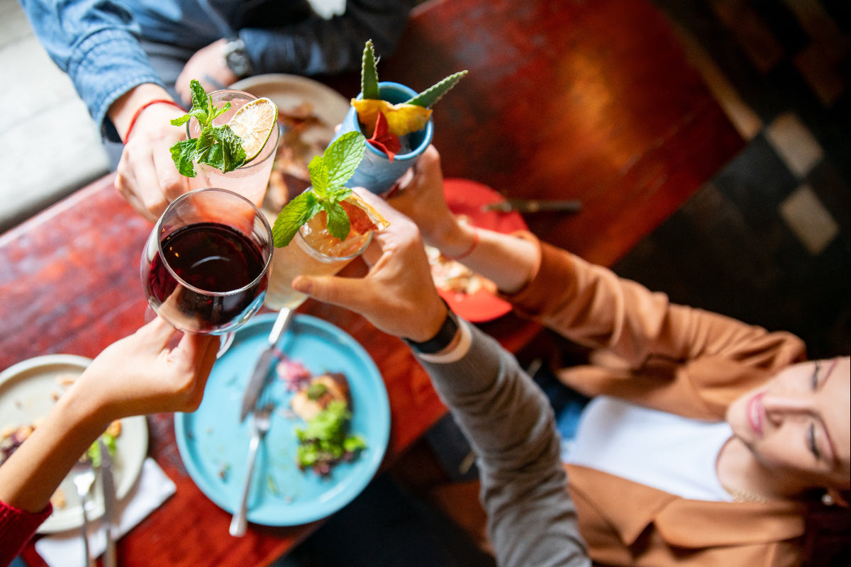 Friends enjoying drinks and food together at a social gathering