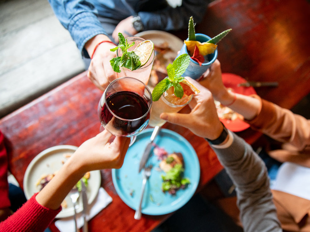People toasting with cocktails at a restaurant